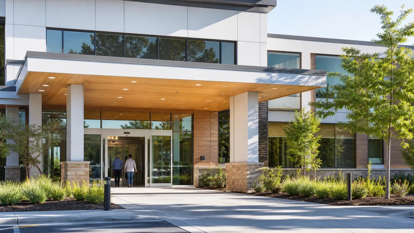 A modern outpatient medical facility entrance with accessible patient arrival.